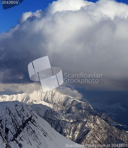 Image of Snow mountains and blue sky with clouds in evening