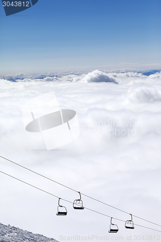 Image of Mountains under clouds and chair-lift