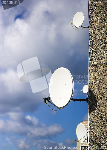 Image of Satellite dishes on the house wall 