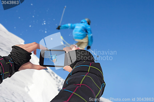 Image of Photographed skiers jump with cell phone