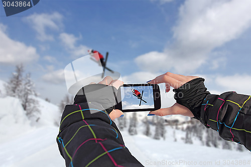 Image of Photographed skiers jump with smart phone