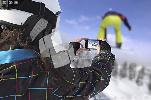 Image of Photographed snowboarder jump with smart phone