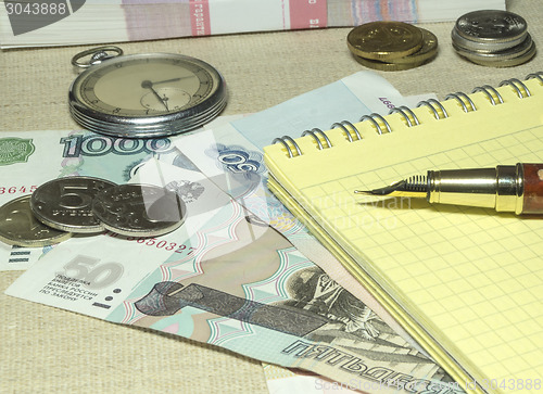 Image of Pocket watches, pen and money