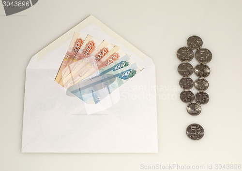 Image of Money in envelope and exclamation mark from coins