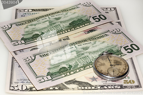 Image of Dollar bank bills and old watch