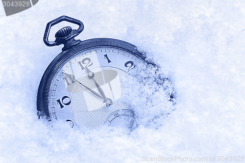 Image of Pocket watch in snow, Happy New Year greeting card