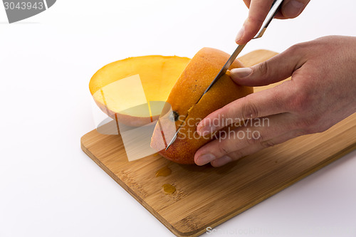 Image of Second Cut Along The Flat Pit Of A Juicy Mango