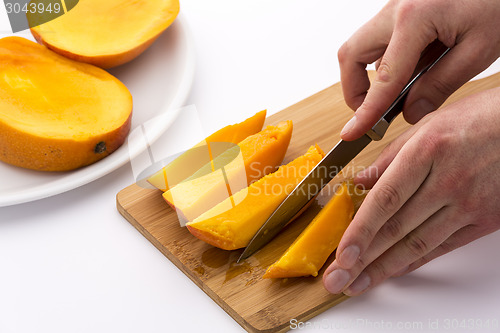 Image of Knife Finished Cutting Off A Fourth Mango Chip