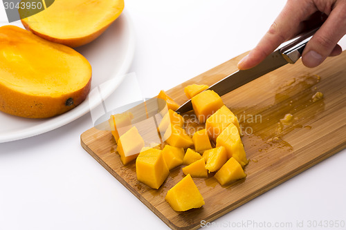 Image of Ripe Mango Fruit Pulp Diced With A Kitchen Knife