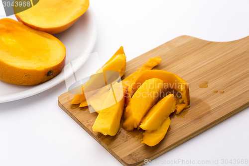 Image of Mango Fruit Pulp And Its Peel On A Cutting Board