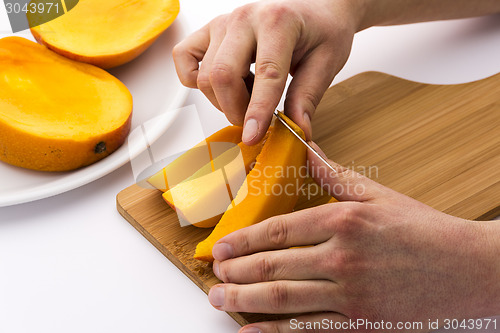 Image of Peeling Away The Mango Skin From A Fruit Chip