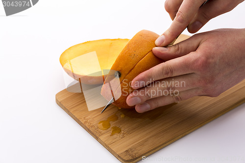 Image of Mango Cut Into Thirds With A Second Section