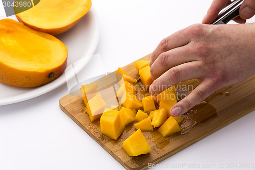 Image of Juicy Mango Fruit Pulp Diced On A Kitchen Board