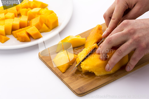 Image of Cutting Juicy Fruit Pulp Around A Mango Pit