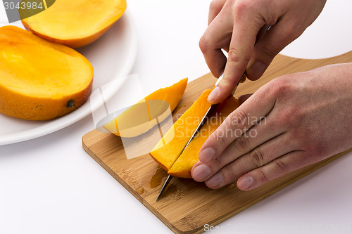 Image of Second Cut Through One Third Of A Trisected Mango