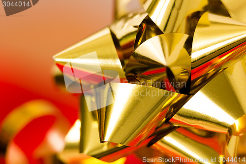 Image of Festive golden bow on a blurred background. macro