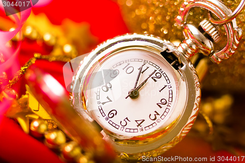 Image of Christmas card. Silver vintage watch on a red background with go