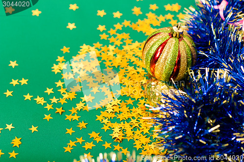 Image of Christmas card. Stars and Christmas decorations on a green