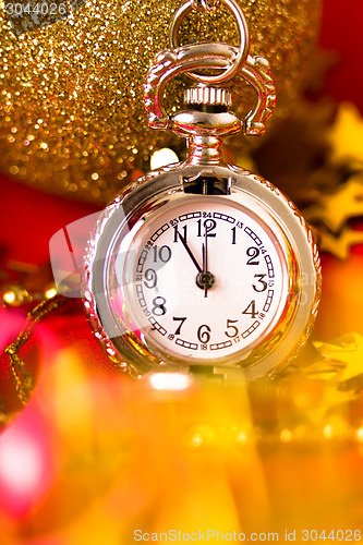 Image of Christmas card. Silver vintage watch on a red background with go