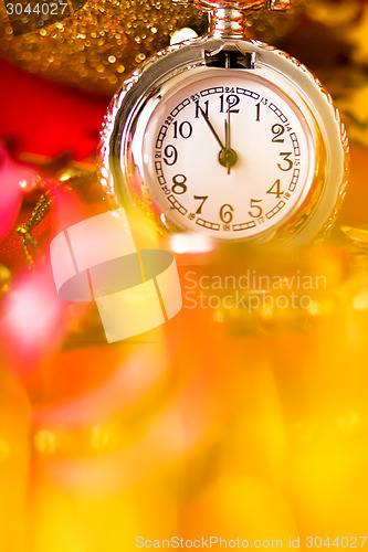 Image of Christmas card. Silver vintage watch on a red background with go