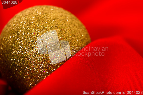 Image of Christmas golden ball on a red. macro