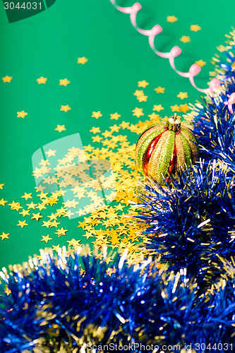 Image of Christmas card. Stars and Christmas decorations on a green