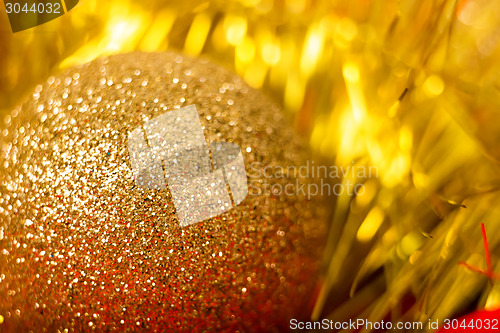 Image of golden ball and tinsel. macro