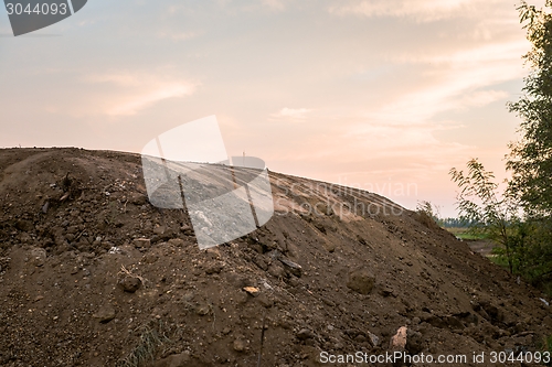 Image of Large pile of soil under blue sky