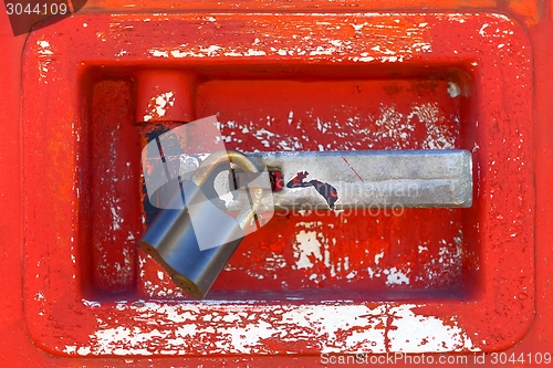 Image of Old door locked with rusty padlock