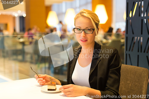 Image of Women eating dessert in fancy restaurant.