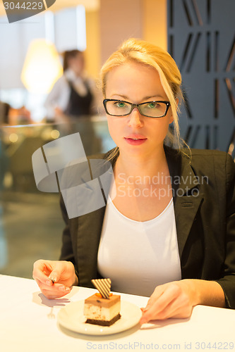 Image of Women eating dessert in fancy restaurant.