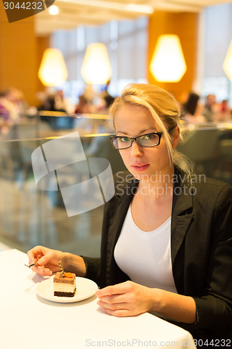 Image of Women eating dessert in fancy restaurant.