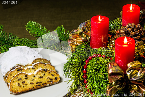 Image of Christmas stollen bakery with Advent wreath with burning candles