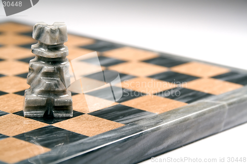 Image of Closeup of marble chess piece and board