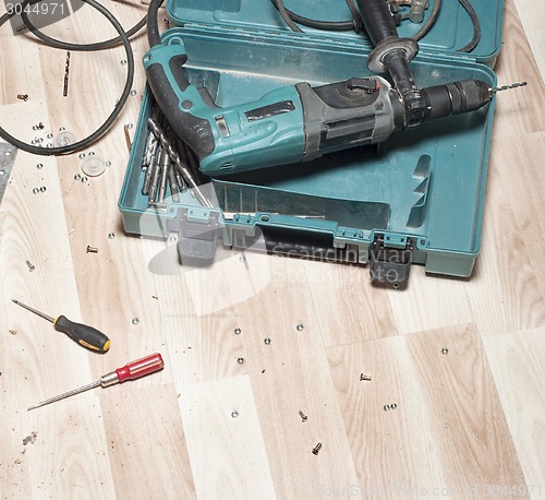 Image of Electric drill on wooden floor