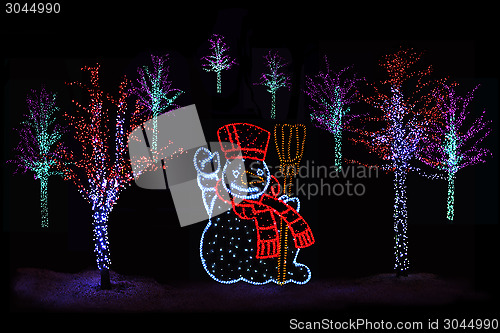 Image of Illuminated Christmas trees and Snowman