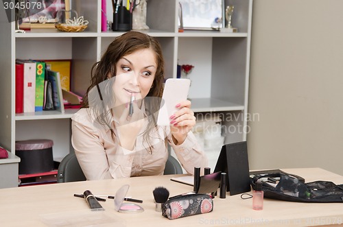 Image of Girl surprised by lipstick