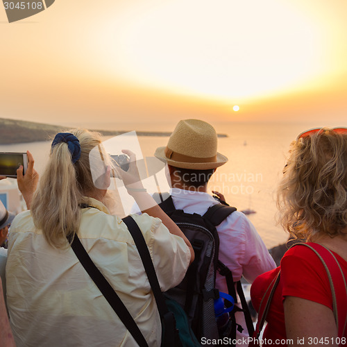Image of Trvellers watching sunset in Oia, Santorini, Greece.