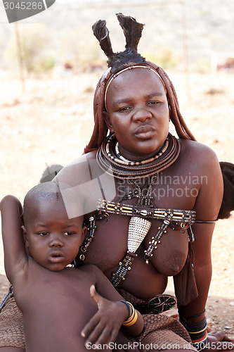 Image of Himba woman with child,in the village