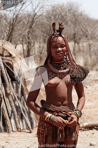 Image of Himba woman with ornaments on the neck in the village