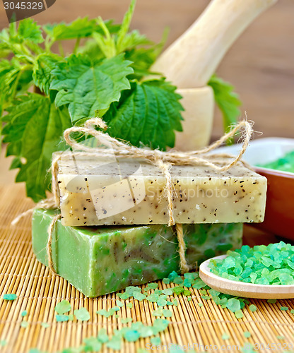 Image of Soap homemade with nettles in mortar on board