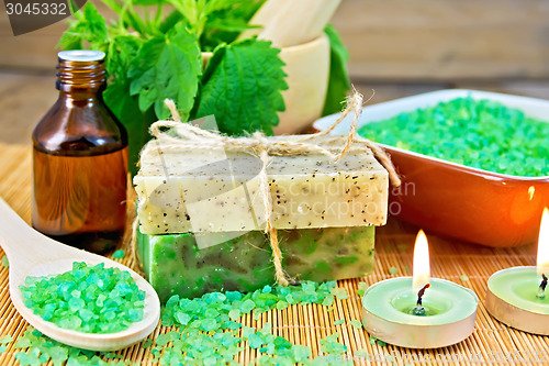 Image of Soap homemade and salt with nettles in mortar on board