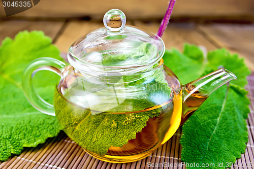 Image of Tea with sage in teapot on bamboo napkin