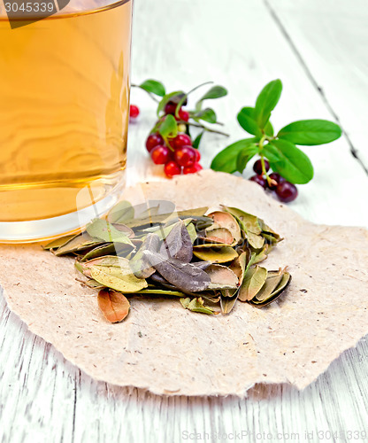 Image of Lingonberry leaf on paper with tea in mug