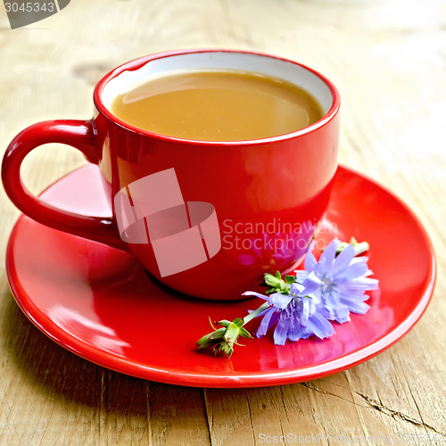 Image of Chicory drink in red cup with flower on board