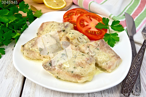 Image of Fish stew in creamy sauce with tomatoes in plate