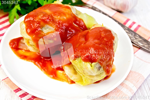 Image of Cabbage stuffed with sauce in plate on board