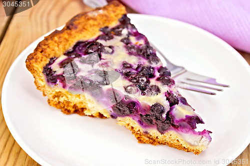 Image of Pie blueberry in plate and napkin on board