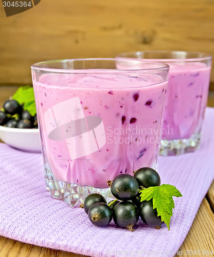 Image of Milkshake with blackcurrants on napkin and board