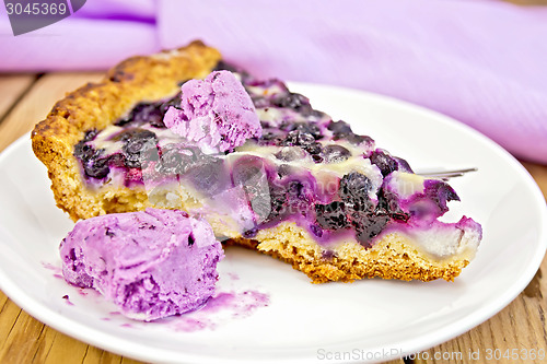 Image of Pie blueberry and ice cream in dish on board